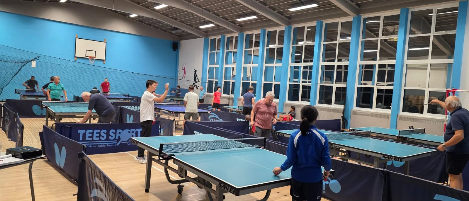 Players enjoying a busy table tennis session at Pankhurst Gym